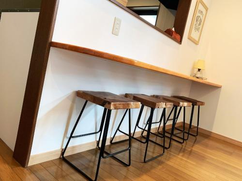 a row of stools sitting under a staircase at Cactus Inn / Vacation STAY 51552 in Miyazaki