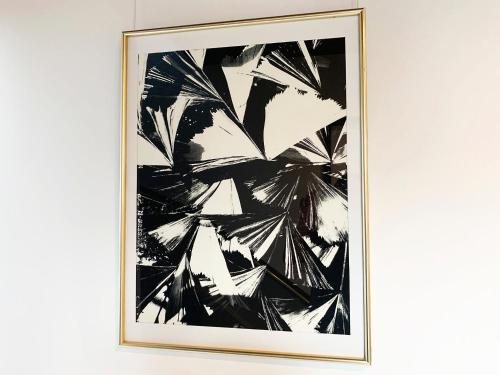 a framed black and white painting on a wall at Cactus Inn / Vacation STAY 51549 in Miyazaki