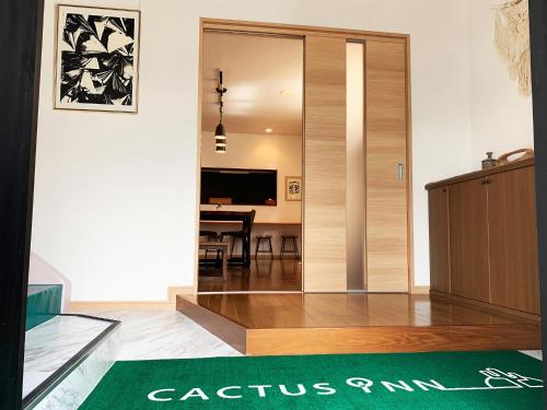 a living room with a sliding door with a table at Cactus Inn / Vacation STAY 51551 in Miyazaki