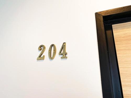 a metal number on a wall next to a door at Cactus Inn / Vacation STAY 51551 in Miyazaki