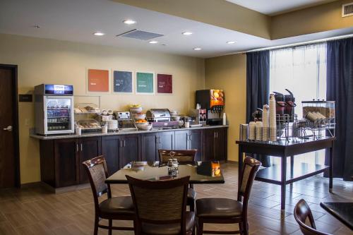 a restaurant with a table and chairs and a counter at Comfort Inn in Saint Clairsville