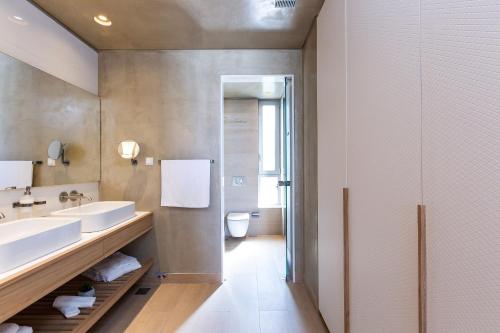 a bathroom with two sinks and a mirror at Sissy Luxury Villa Chania in Plataniás
