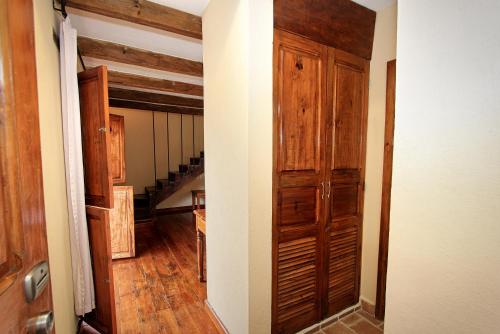 a hallway with a wooden door in a house at Hotel San Marcos in San Cristóbal de Las Casas