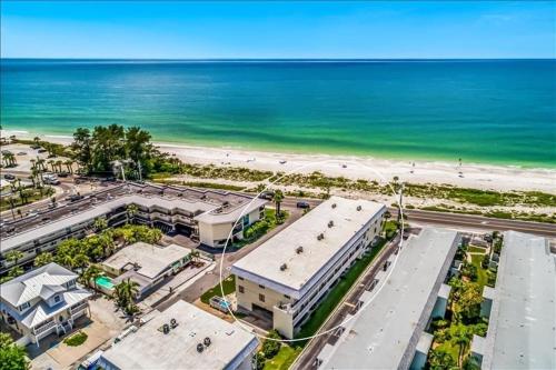 an aerial view of a building next to the beach at Gulf Watch 204 Condo in Bradenton Beach