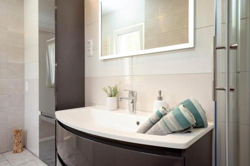 a bathroom with a sink and a mirror at Villa Vista Hvar in Jelsa