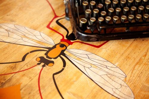 a butterfly decoration on a wooden table next to an abacus at At Home In Maremma in Istia dʼOmbrone