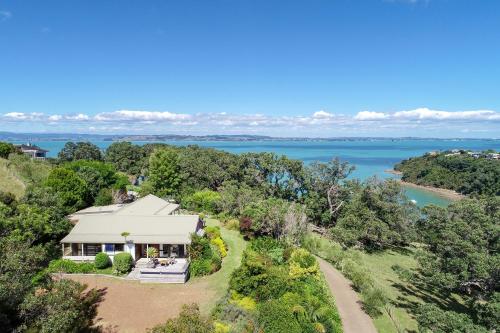 an aerial view of a house with a view of the water at Waiheke Island Vineyard Holiday Houses in Surfdale