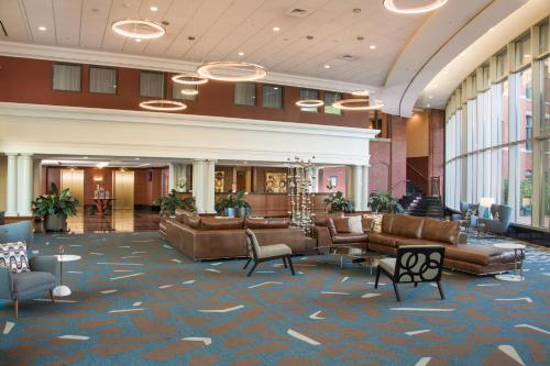 a lobby with couches and chairs in a building at Wellsworth Hotel in Southbridge