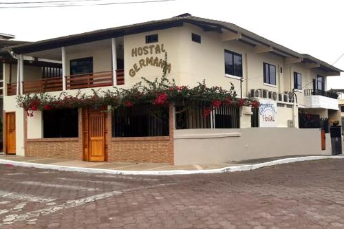 a building with flowers on the front of it at Hospedaje Germania in Puerto Ayora