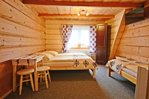 Кровать или кровати в номере Pokoje gościnne Pod Limbami