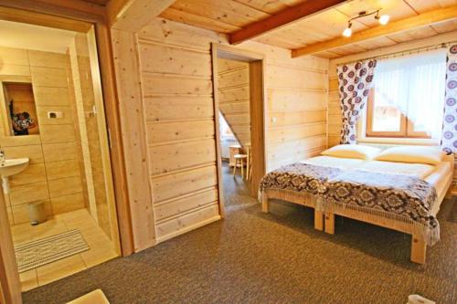 a bedroom with a bed and a walk in shower at Pokoje gościnne Pod Limbami in Male Ciche