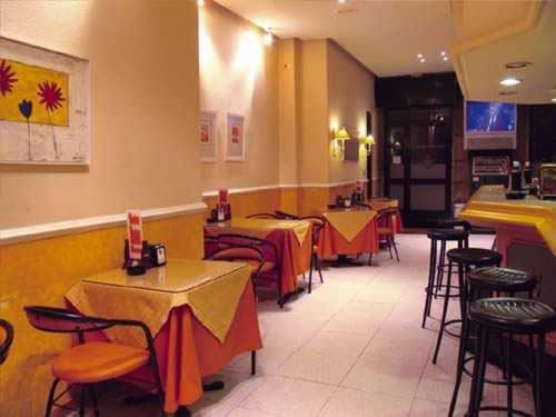 a restaurant with tables and chairs in a room at Hotel Casablanca Vigo in Vigo