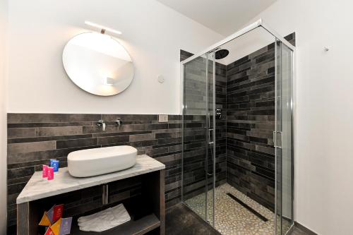 a bathroom with a shower and a sink and a mirror at Du Parc Hotel in Sauze dʼOulx
