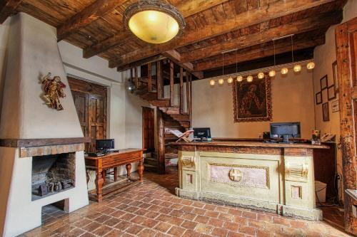 a living room with a fireplace and a piano at Hotel San Marcos in San Cristóbal de Las Casas