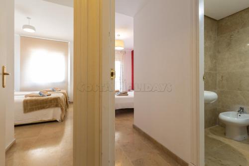 - une salle de bains avec toilettes et un lit dans une chambre dans l'établissement marina duquesa 806, à Manilva