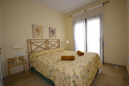a bedroom with a bed and a large window at marina duquesa 616 in Manilva