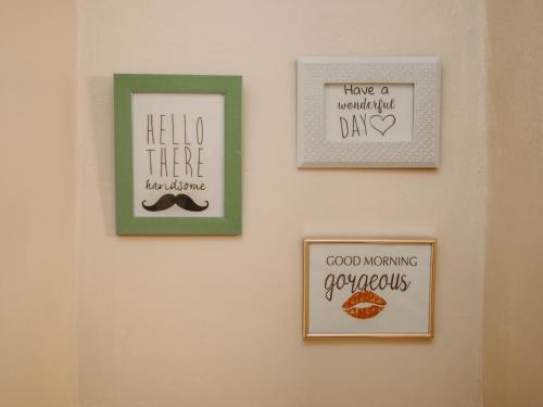three pictures on a wall with signs on it at Business and Travel Central Apartment in Timişoara