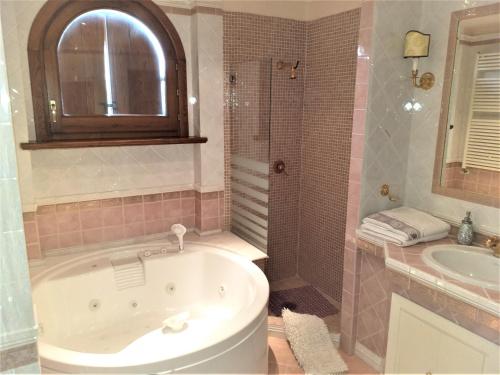 a bathroom with a tub and a shower and a sink at B&B Villa Roberta in Viterbo