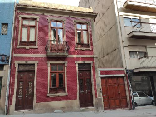 
a red brick building with a red door at Sweet Swell in Porto
