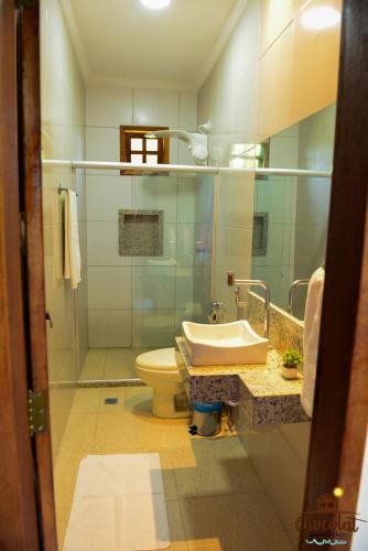 a bathroom with a sink and a toilet at Chocolat Barra Beach in Marau