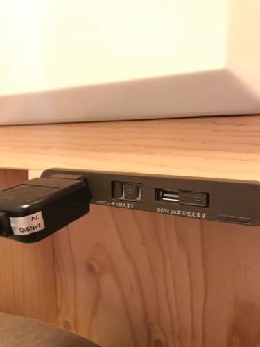 a computer monitor sitting on top of a wooden table at ちゃぶだい Guesthouse,Cafe&Bar in Kawagoe