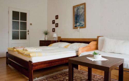 a bedroom with a large bed and a coffee table at Privat No. 40 in Telč