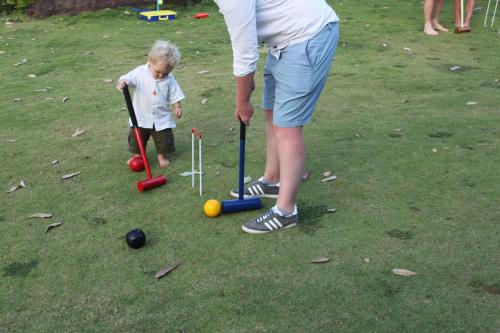 a man and a child playing with balls and bats at Jungle Tide in Kandy
