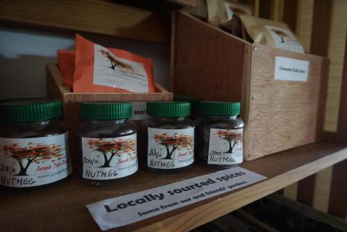 four jars of honey sitting on a shelf at Jungle Tide in Kandy