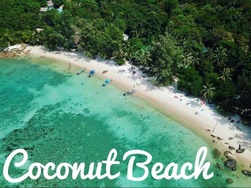 an aerial view of a beach with people in the water at Coconut Beach Bungalows in Chaloklum