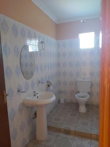 a bathroom with a sink and a toilet at Sahara Gardens Bomet in Bomet