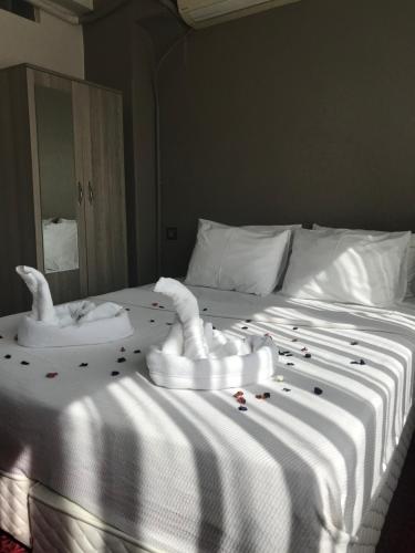 a white bed with white pillows and white towels at Hotel Sultanahmet in Istanbul
