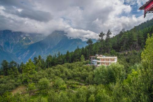 a house on the side of a hill with trees at The Wild Trails by Livingstone in Kalpa