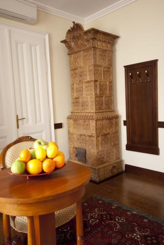 a bowl of fruit on a wooden table in a room at Trifecta Udvarház in Tállya