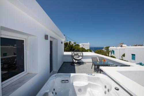 a bath tub on the balcony of a house at Zannis Hotel in Mikonos