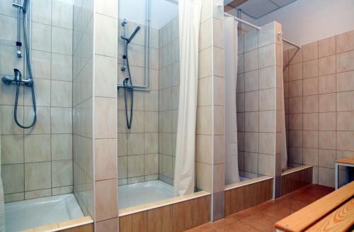 a bathroom with a shower and a tub at Warsaw Hostel Centrum Private Rooms & Dorms in Warsaw