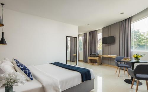 Postel nebo postele na pokoji v ubytování Altos Hotel