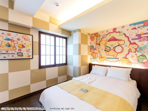 a bedroom with a bed and a wall with cartoons on it at HOTEL OKINAWA WITH SANRIO CHARACTERS in Naha