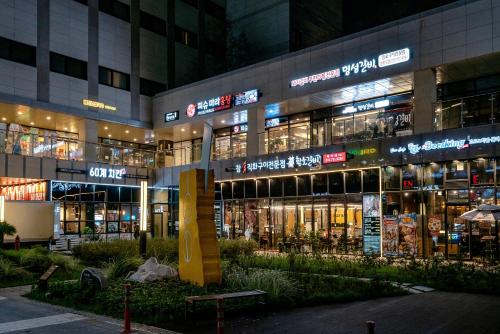 a large building with many signs on it at night at Days Hotel & Suites by Wyndham Incheon Airport in Incheon