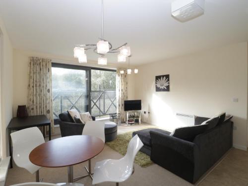 a living room with a couch and a table at Flat 2 in Street