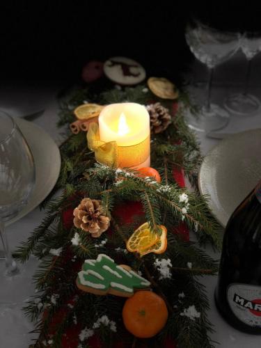 a candle on a table with a christmas tree at Синевирський Перевал in Synevyr