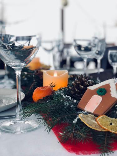 a table with wine glasses and a plate of food at Синевирський Перевал in Synevyr