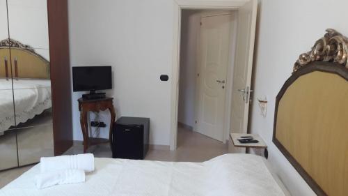 a bedroom with a bed and a television in it at La stanza del paradiso in Torre Pali 
