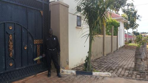 a police officer standing in front of a garage door at The Pearl Inn in Koboko