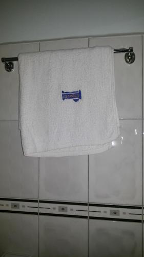a towel hanging on a towel rack in a bathroom at The Pearl Inn in Koboko