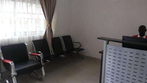 a waiting room with two chairs and a table at The Pearl Inn in Koboko