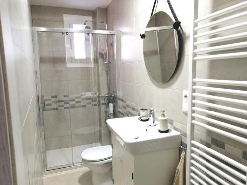 a bathroom with a toilet and a sink and a shower at Casa MILA , Centro Histórico in Logroño