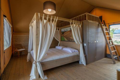 a bedroom with a bunk bed and a ladder at Castello di Serragiumenta in Firmo