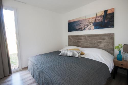 1 dormitorio con 1 cama y una foto en la pared en RCN Vakantiepark de Schotsman Bungalow de Boei, en Kamperland
