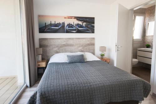 1 dormitorio con 1 cama y una pintura en la pared en RCN Vakantiepark de Schotsman Bungalow de Bevelander, en Kamperland