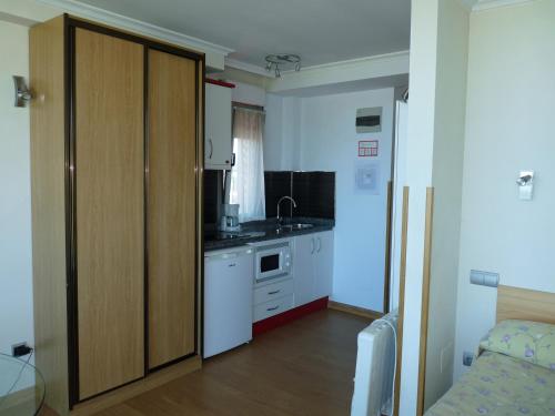 a small kitchen with a sink and a cabinet at Apartamentos Maradentro in Soto de la Marina